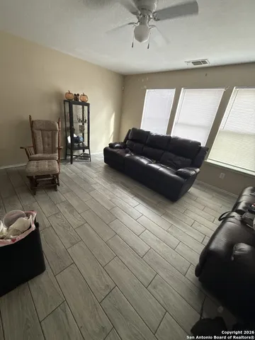 a living room with furniture and a potted plant
