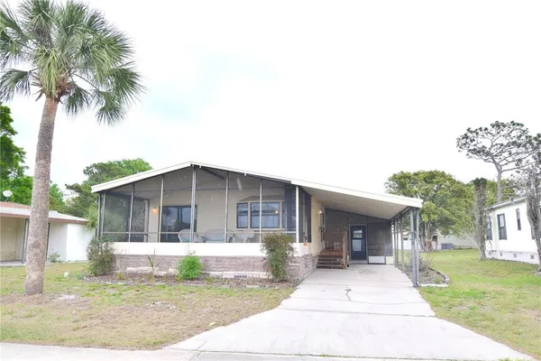 a front view of a house with a garden and yard