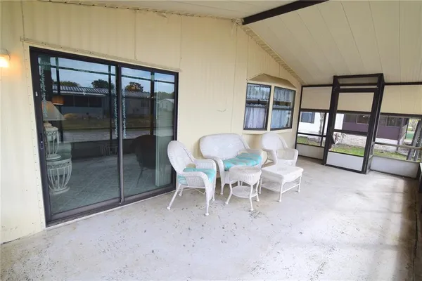 a dining room with furniture and front door