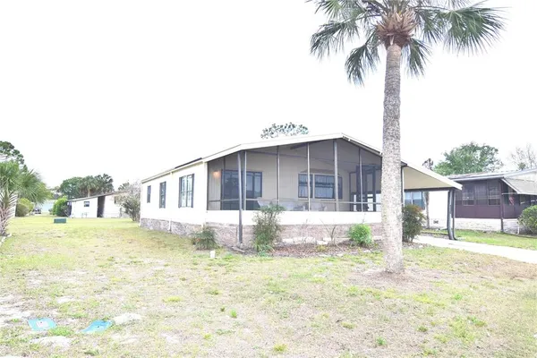 a front view of a house with a yard table and chairs