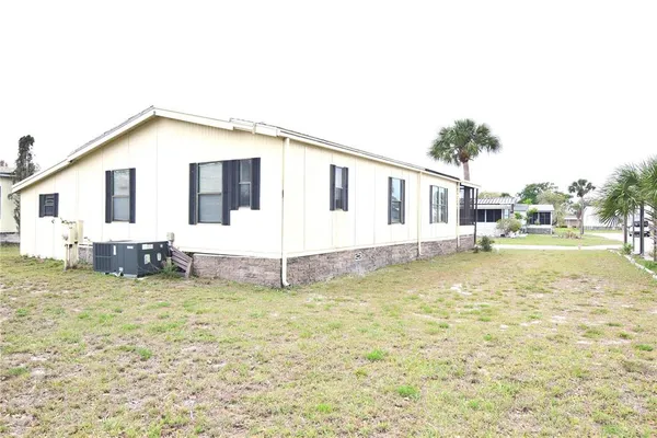 a view of a house with swimming pool and sitting area