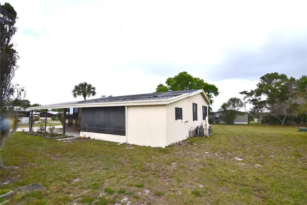 a view of a house with a backyard