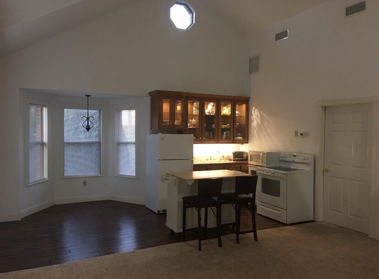 101 Southeast 6th Plainview, TX 79072 - Photo 11 of 31 a kitchen with a sink cabinets and wooden floor