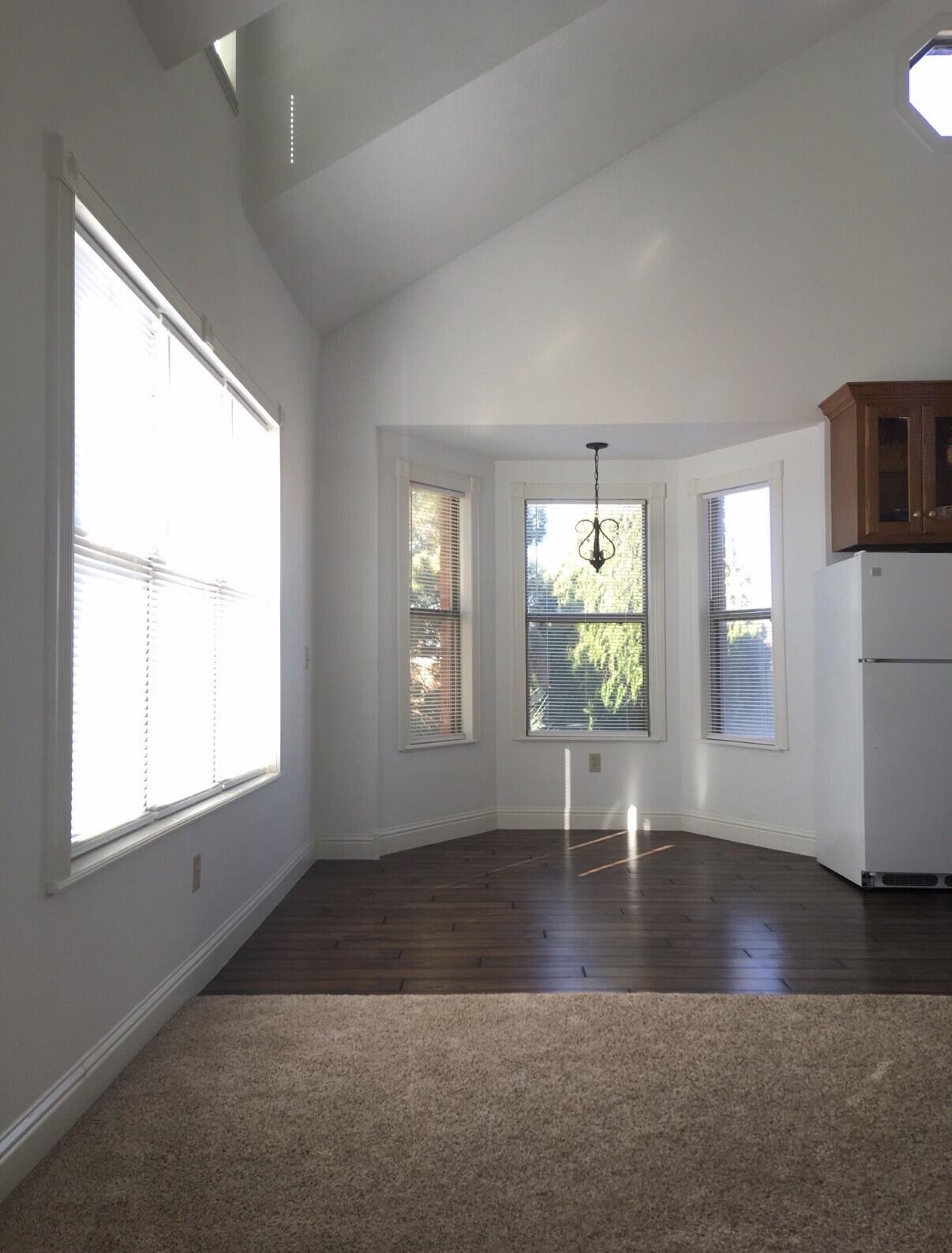 101 Southeast 6th Plainview, TX 79072 - Photo 13 of 31 an empty room with wooden floor and windows