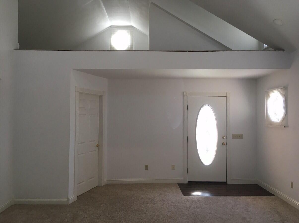 101 Southeast 6th Plainview, TX 79072 - Photo 26 of 31 an empty room with wooden floor and windows