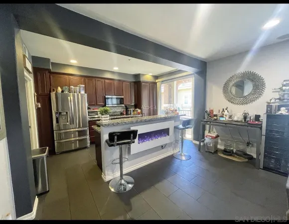 a kitchen with stainless steel appliances a stove and cabinets