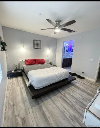 a bedroom with a bed and a chandelier