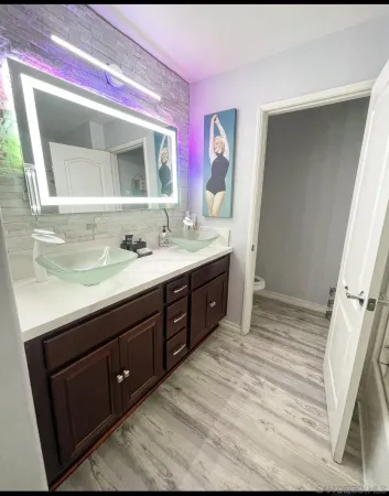 a bathroom with a sink vanity and mirror