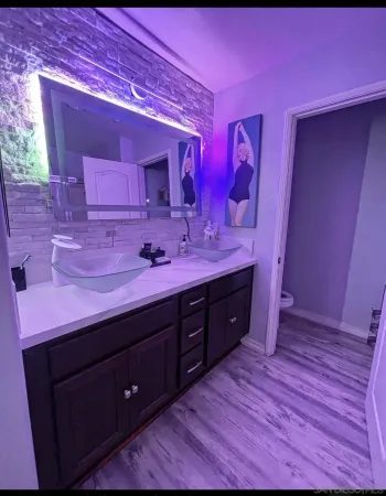 a spacious bathroom with a sink and a mirror
