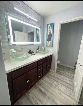 a spacious bathroom with a double vanity sink and a mirror