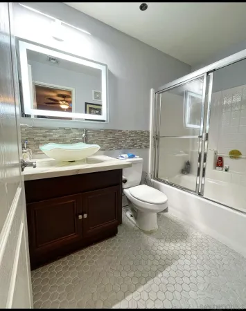a bathroom with a sink toilet and shower