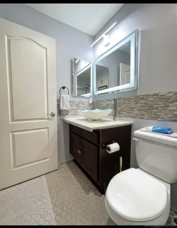 a bathroom with a toilet sink and mirror