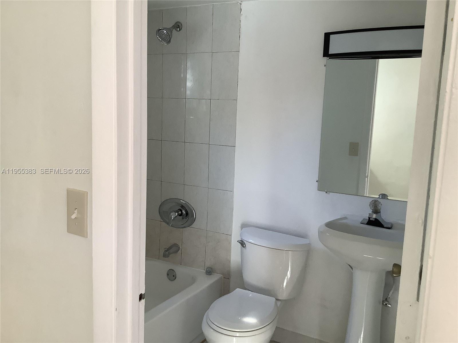 3620 Southwest 13th Terrace, Unit 3 Miami, FL 33145 - Photo 8 of 8 a white toilet sitting next to a bathroom sink