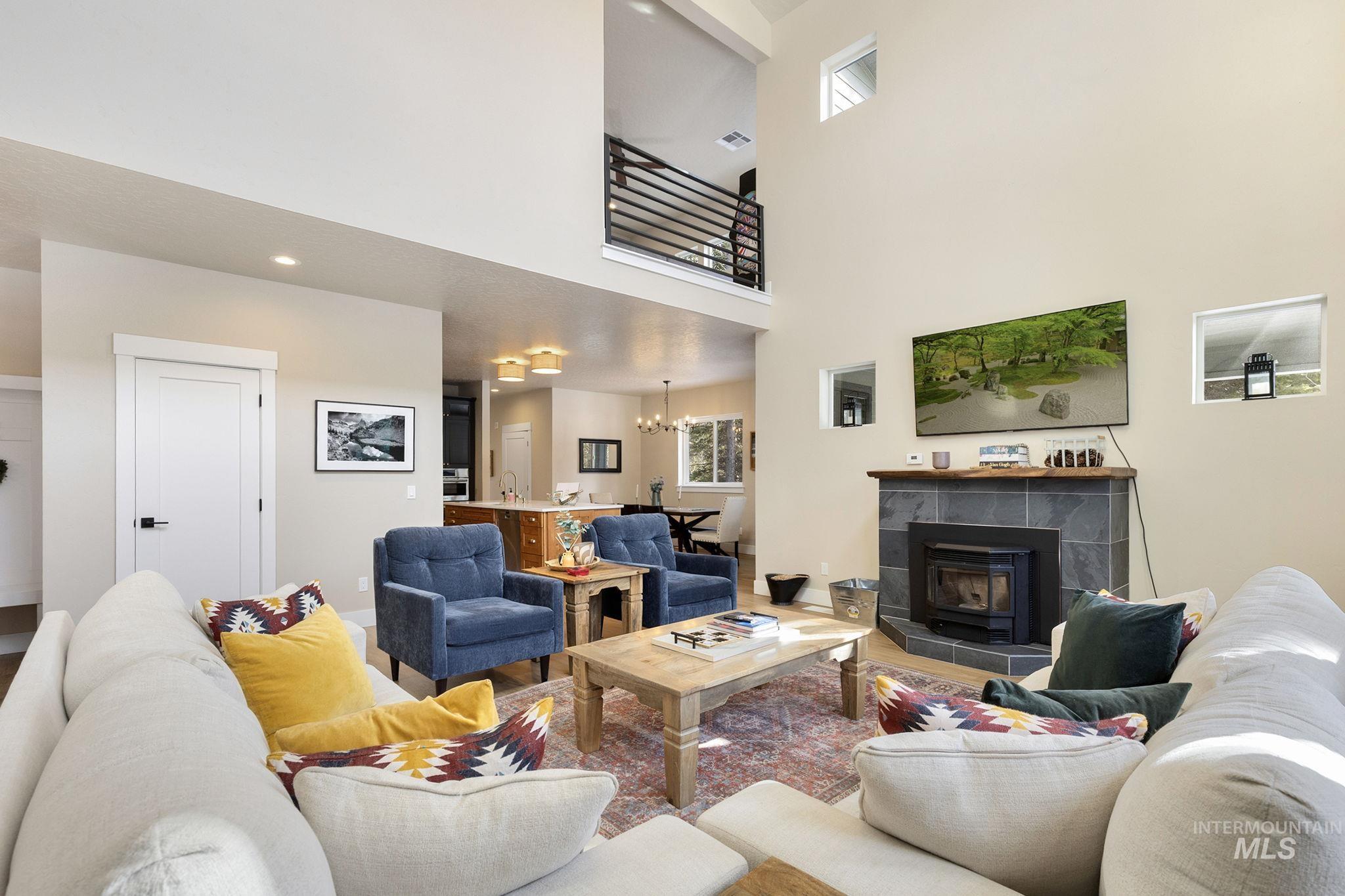 127 Jacks Loop Donnelly, ID 83615 - Photo 11 of 46 Living area with suspended lighting, a high ceiling, and wood finished floors