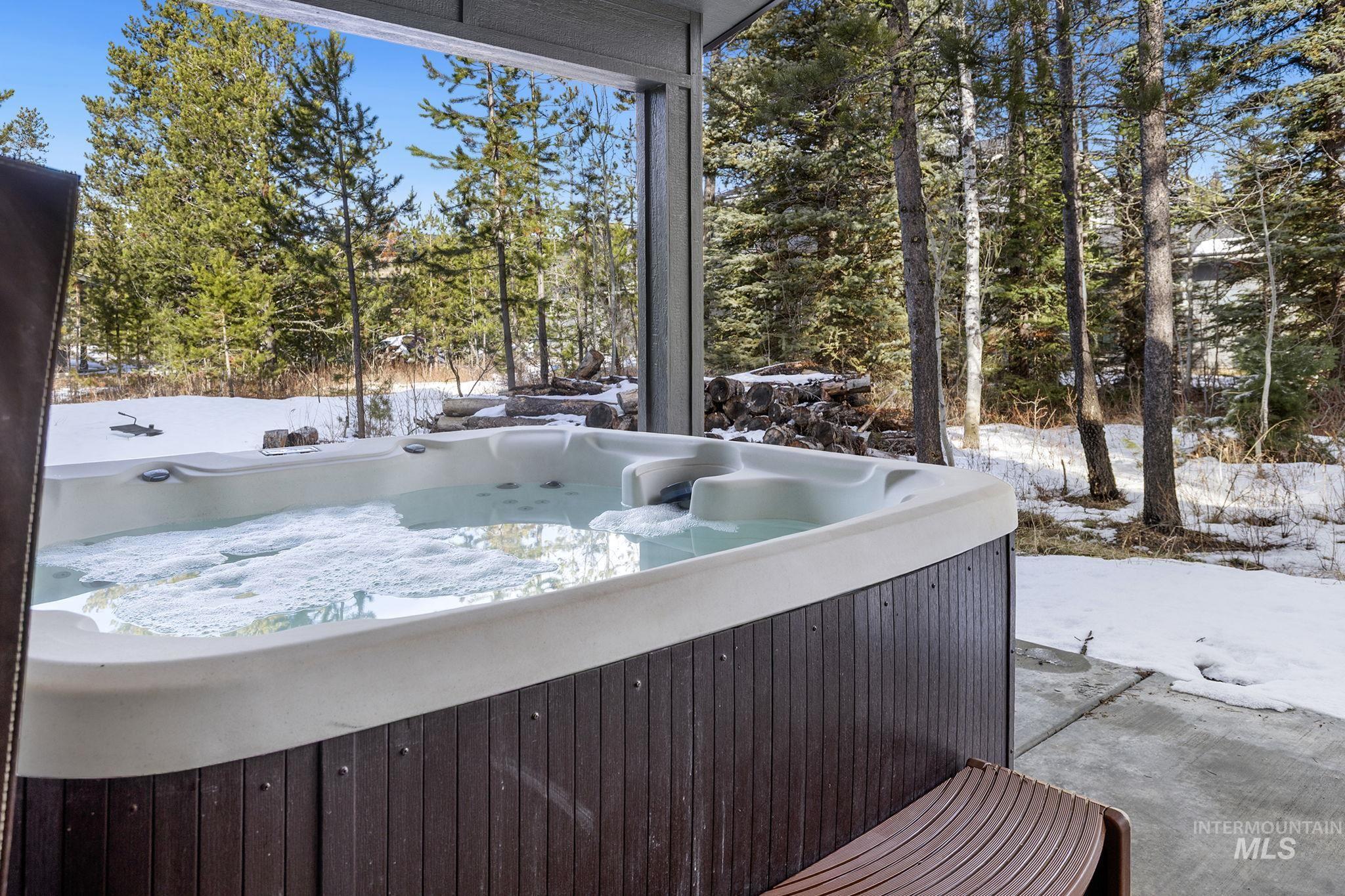 127 Jacks Loop Donnelly, ID 83615 - Photo 35 of 46 Exterior space featuring a hot tub and view of scattered trees