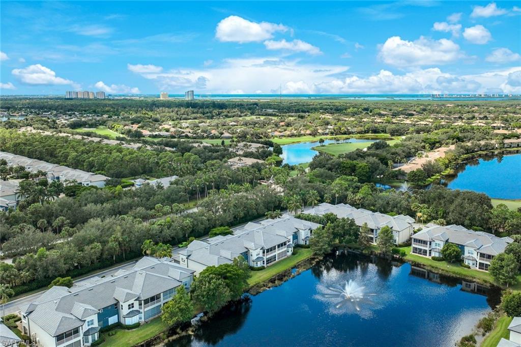 3530 Lansing Loop, Unit 202 Estero, FL 33928 - Photo 28 of 35 an aerial view of a city with lots of residential buildings ocean and mountain view in back