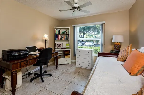 a bedroom with a bed and a desk