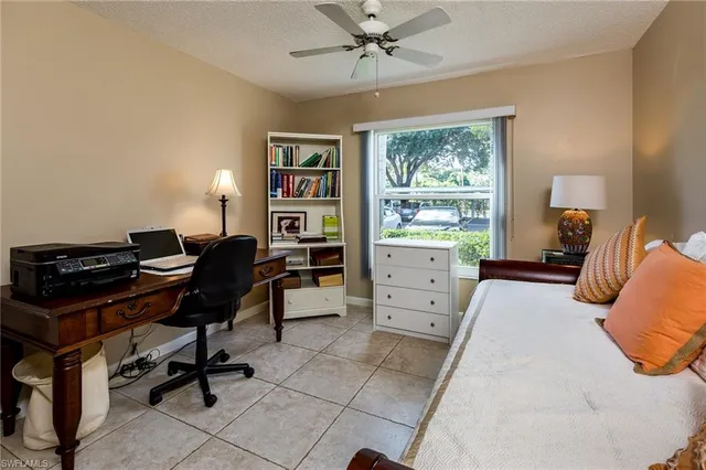 a bedroom with a bed and a desk