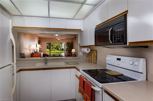 a kitchen with stainless steel appliances granite countertop a stove a microwave and a sink