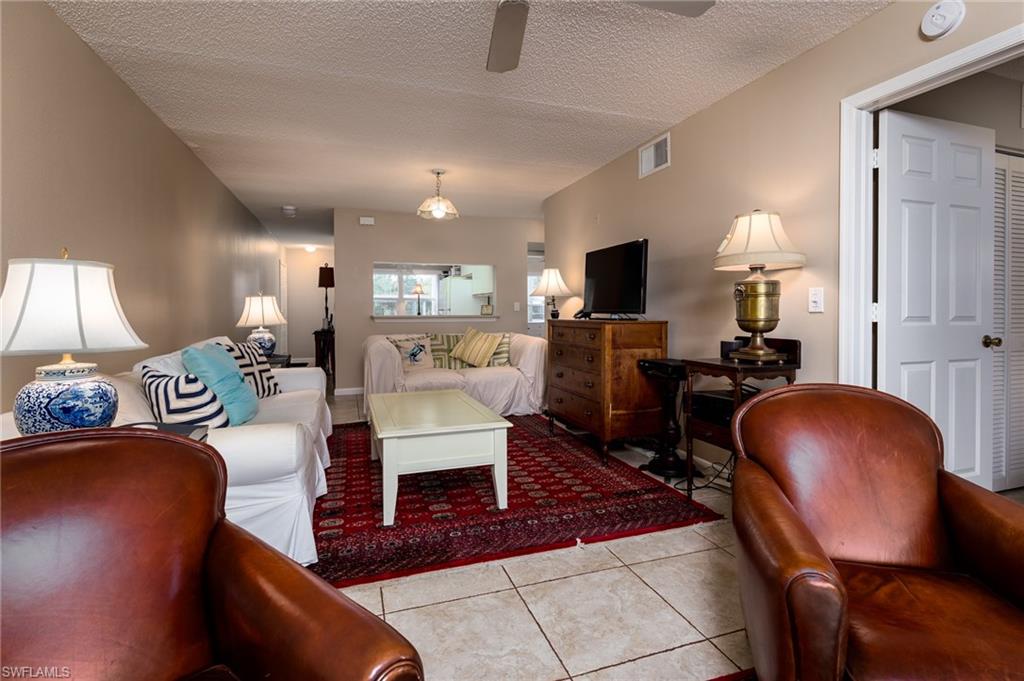 109 Wading Bird Circle, Unit V104 Naples, FL 34110 - Photo 8 of 17 a living room with furniture