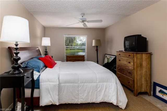 a bedroom with a bed and a tv