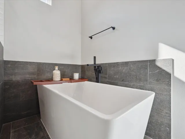 a white bath tub sitting in a bathroom