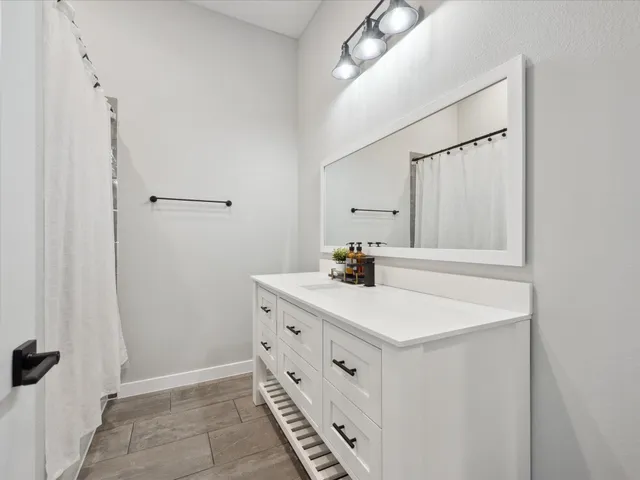 a bathroom with a sink and a mirror