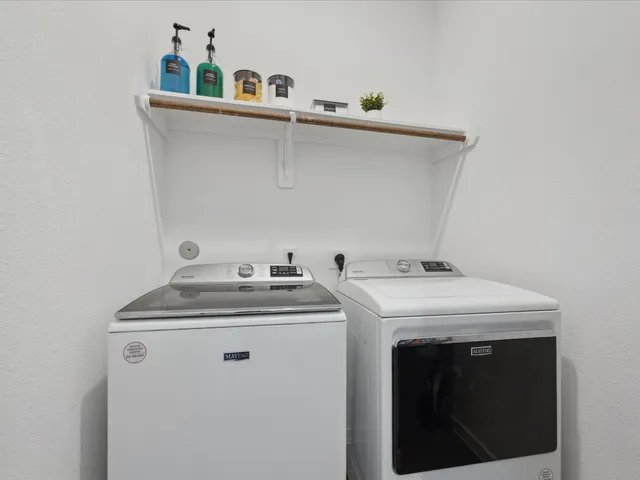 a utility room with sink dryer and washer