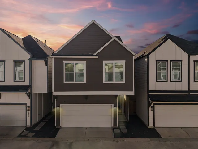 a front view of a house with a garage