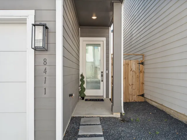 a view of a hallway with wooden walls and windows