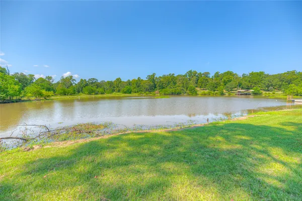 a view of a lake with houses in the back