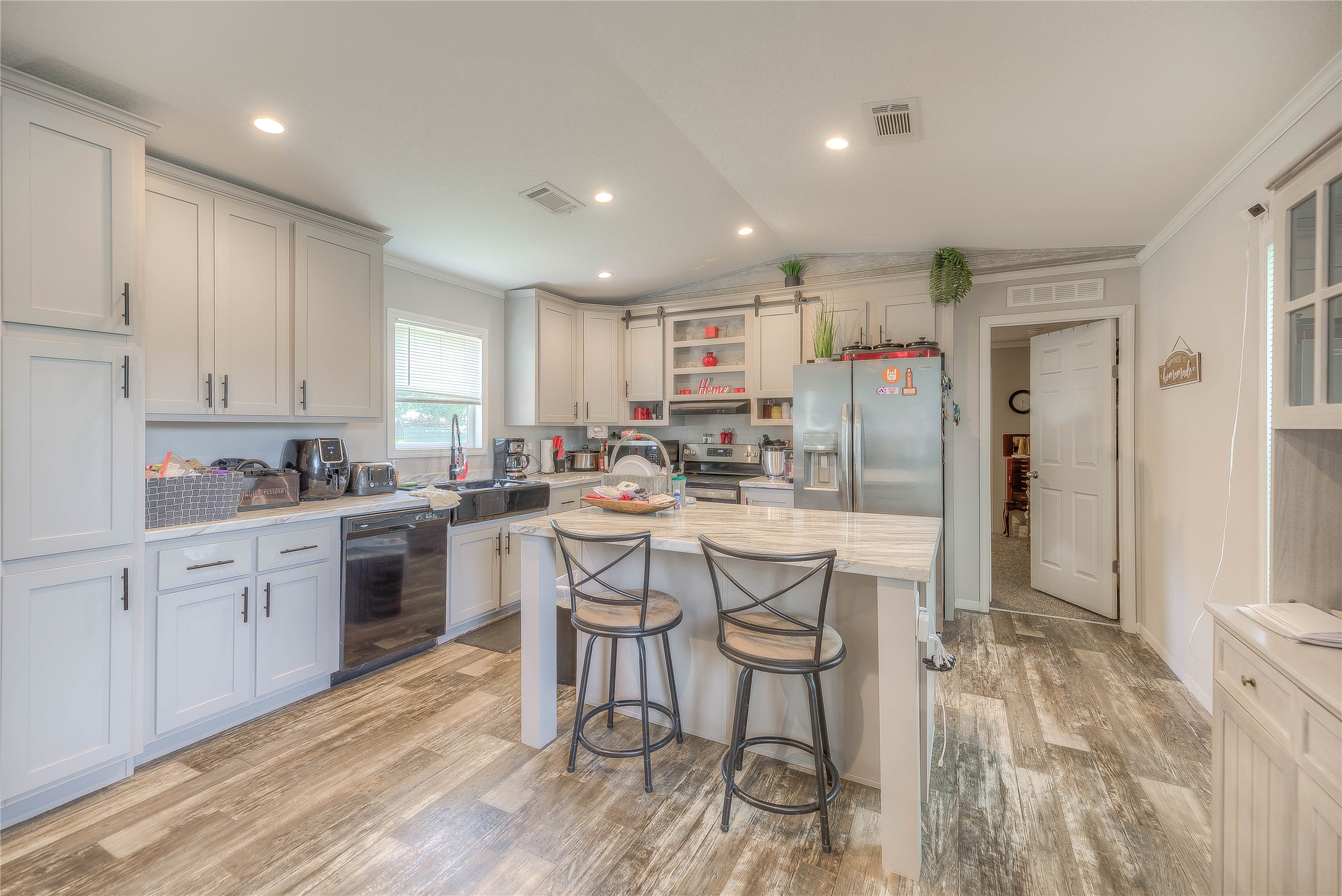 363 Deer Run Road Trinity, TX 75862 - Photo 13 of 28 a kitchen with stainless steel appliances kitchen island granite countertop a refrigerator and cabinets