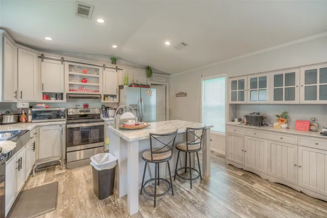 a kitchen that has a lot of cabinets in it and appliances