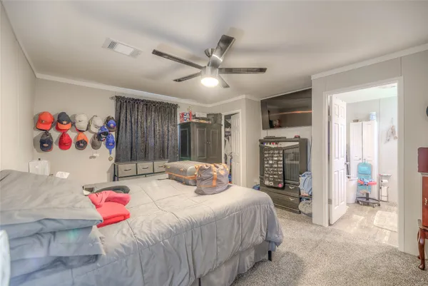 a bedroom with a bed closet and a large mirror