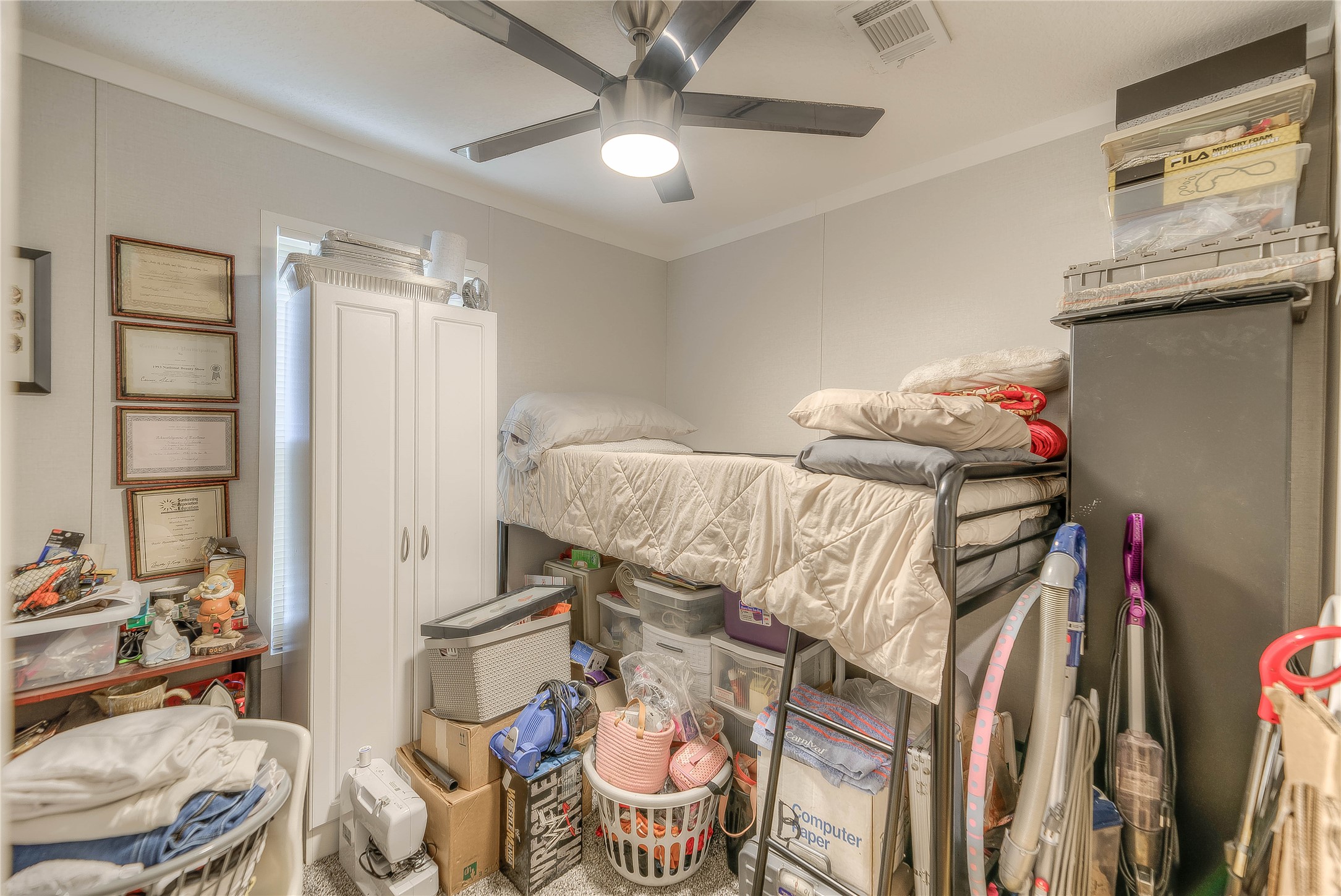 363 Deer Run Road Trinity, TX 75862 - Photo 19 of 28 a bedroom with a bed and a chandelier