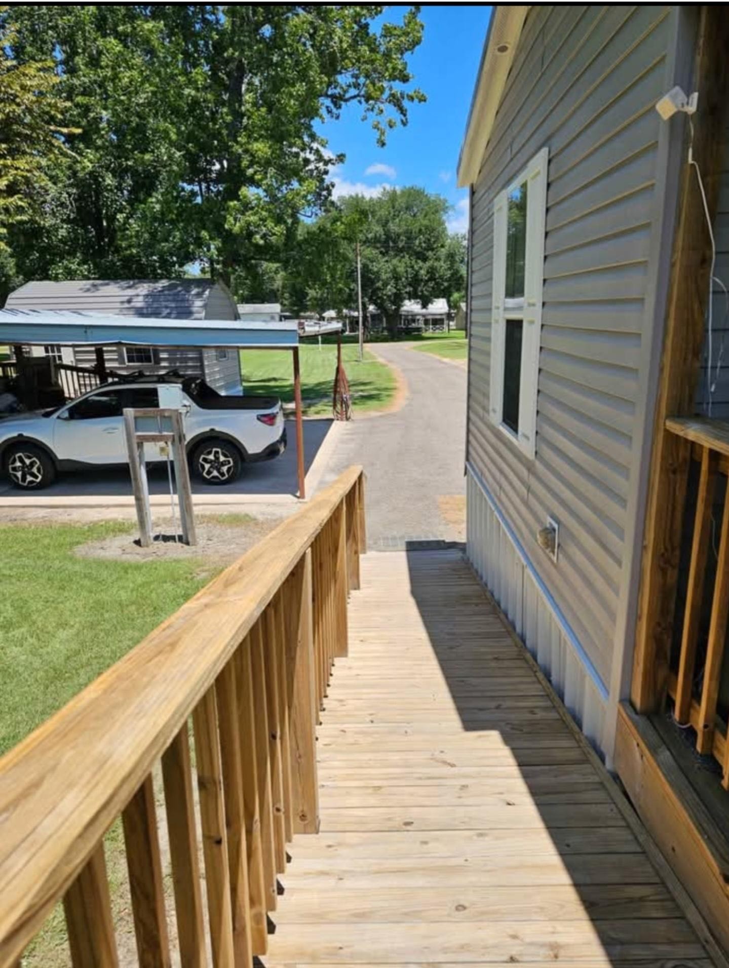 363 Deer Run Road Trinity, TX 75862 - Photo 4 of 28 a balcony with wooden floor and yard in the back