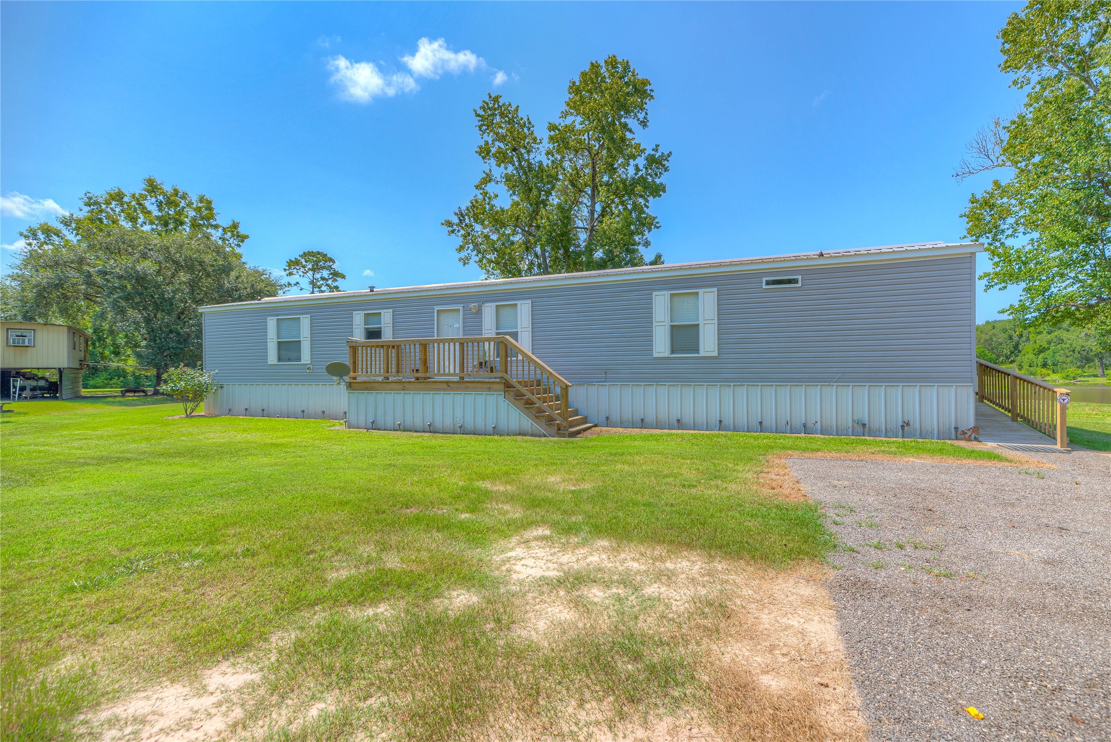 363 Deer Run Road Trinity, TX 75862 - Photo 6 of 28 a view of a backyard with plants and a patio