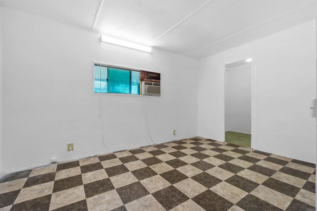 12044 Royal Road, Unit 93 El Cajon, CA 92021 - Photo 11 of 29 a bedroom with a black and white checkered floor