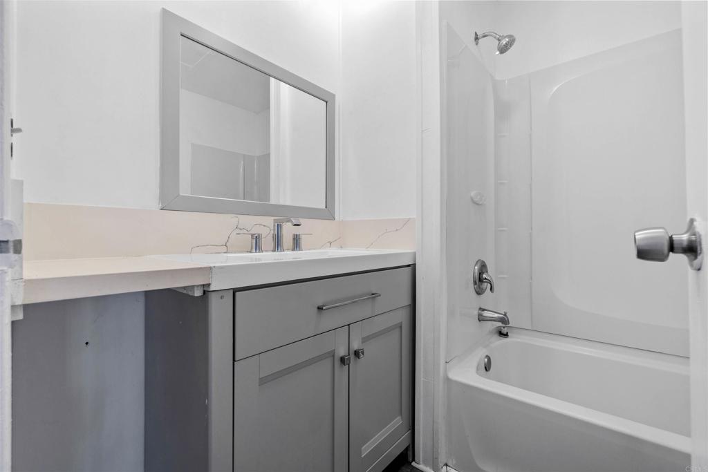12044 Royal Road, Unit 93 El Cajon, CA 92021 - Photo 15 of 29 a bathroom with a tub sink double vanity and mirror