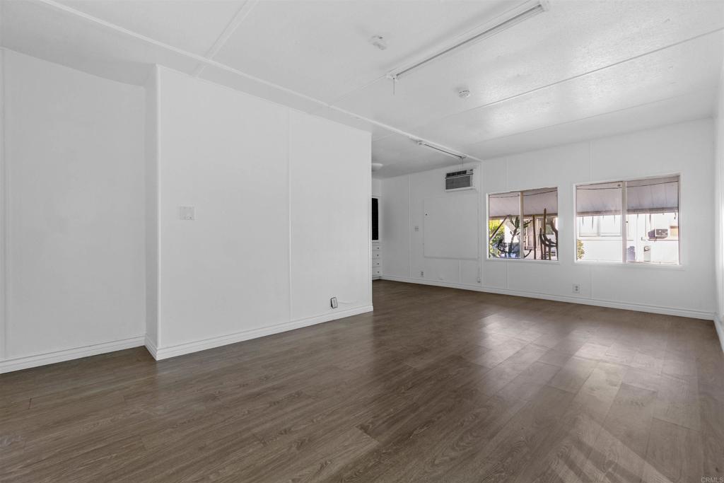 12044 Royal Road, Unit 93 El Cajon, CA 92021 - Photo 2 of 29 an empty room with wooden floor and windows