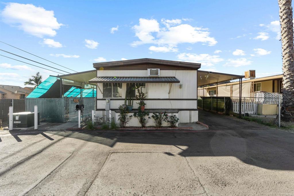 12044 Royal Road, Unit 93 El Cajon, CA 92021 - Photo 22 of 29 a front view of a house with a garage