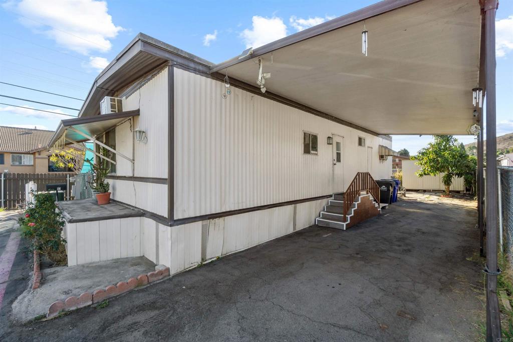 12044 Royal Road, Unit 93 El Cajon, CA 92021 - Photo 23 of 29 a view of a house with wooden floor and iron fence