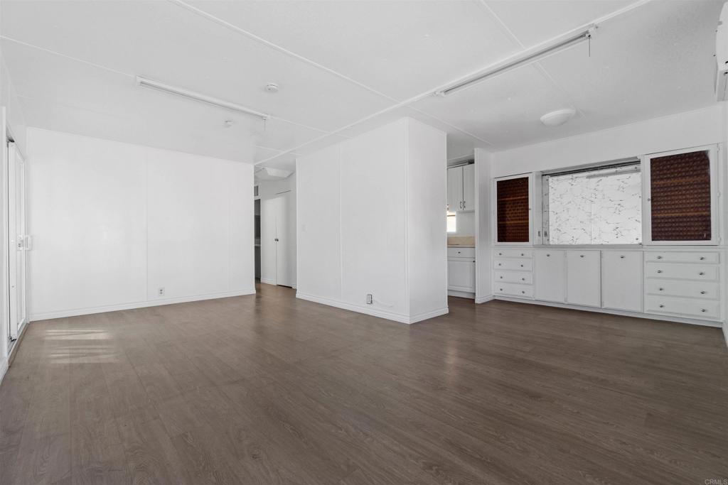 12044 Royal Road, Unit 93 El Cajon, CA 92021 - Photo 3 of 29 a view of a livingroom with wooden floor and cabinet