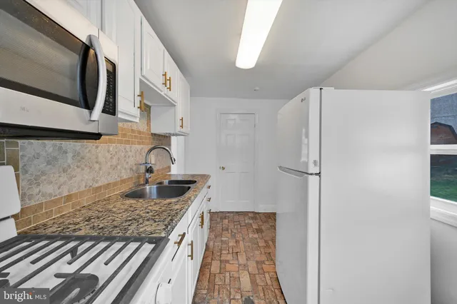 a kitchen with a refrigerator and a stove
