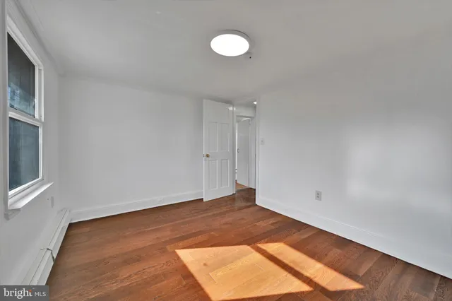 a view of a room with wooden floor and window