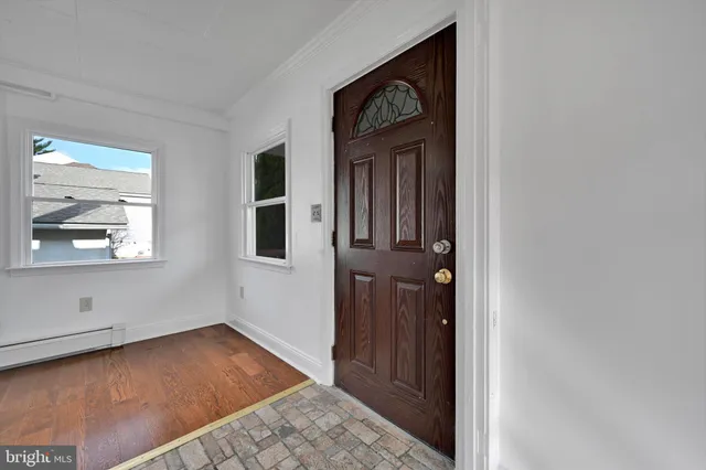 a view of an entryway with wooden floor