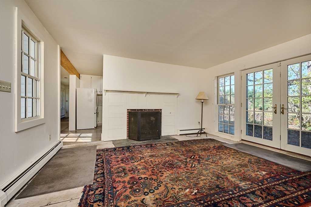 41 Buckland Road Hawley, MA 01339 - Photo 11 of 42 a view of a livingroom with an empty space and a fireplace