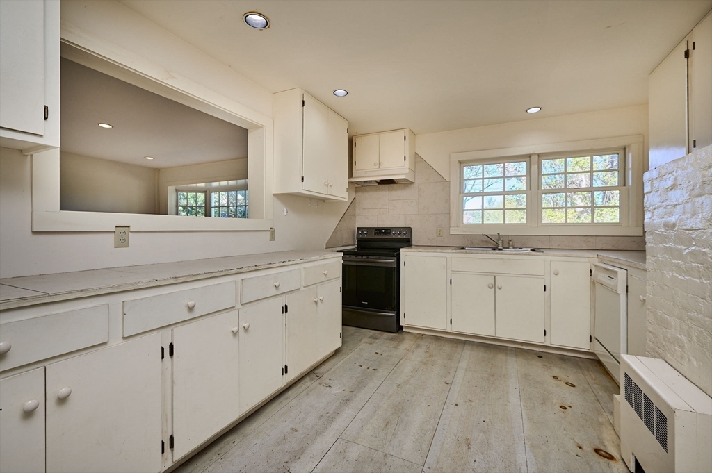 41 Buckland Road Hawley, MA 01339 - Photo 14 of 42 a view of a kitchen with white cabinets stove and sink
