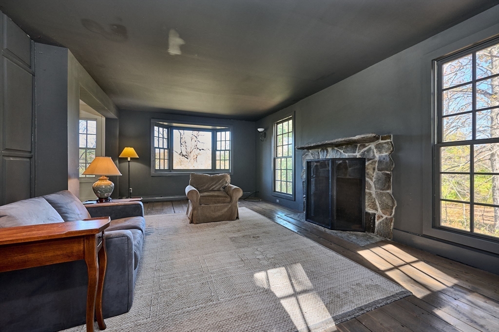 41 Buckland Road Hawley, MA 01339 - Photo 19 of 42 a living room with furniture a window and a fireplace