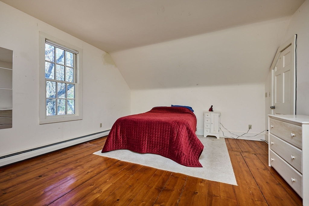 41 Buckland Road Hawley, MA 01339 - Photo 20 of 42 a bed sitting in a bedroom next to a window